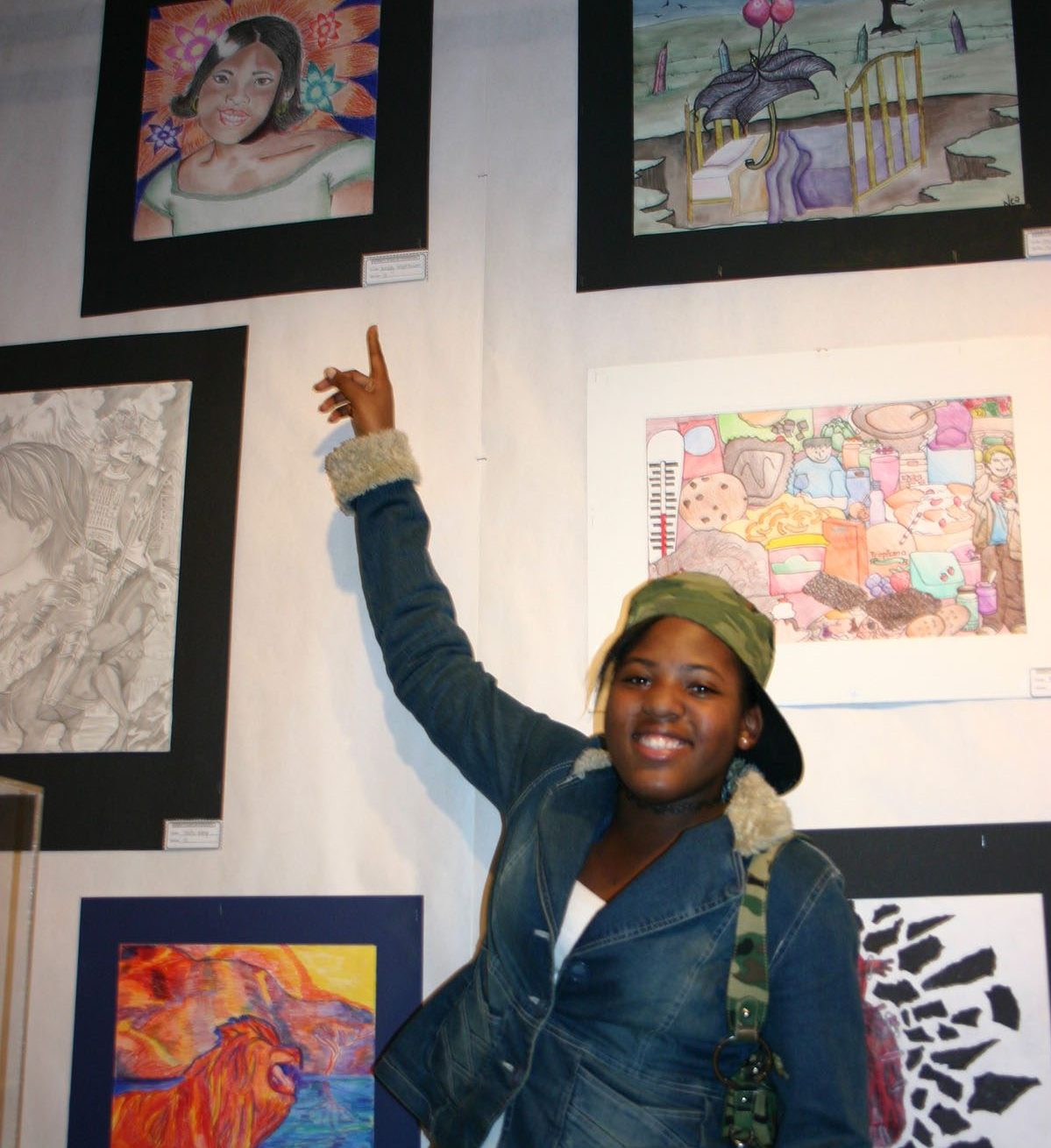 Photo of Student pointing out their artwork
